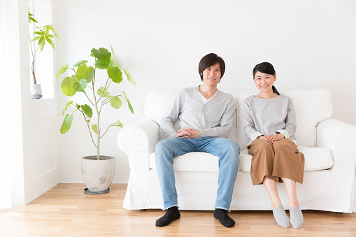 young asian couple in living room lifestyle image