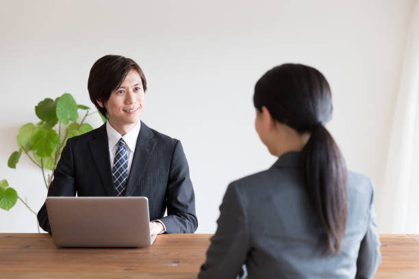 asian business person talking in office asian business person talking in office talking two people business talk business stock pictures, royalty-free photos & images