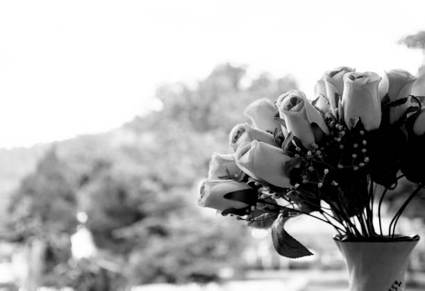 istock black and white roses artificial flowers in vases 1026349652