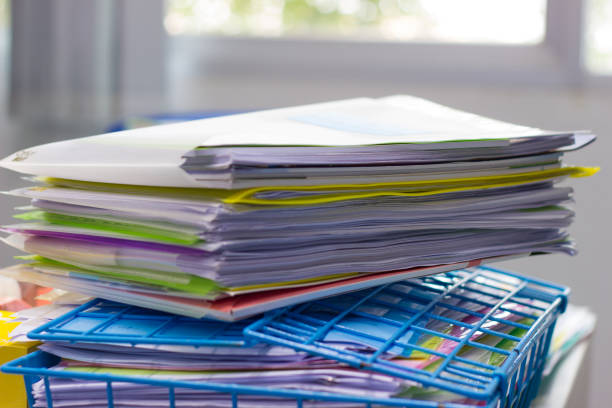 istock File folder and Stack of business report paper file on the table in a work office 1026390348