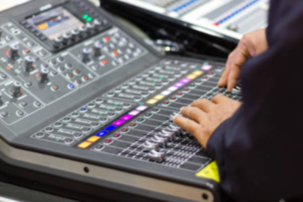 istock Men's hands are controlling the console of a large hi-fi system 1026390898
