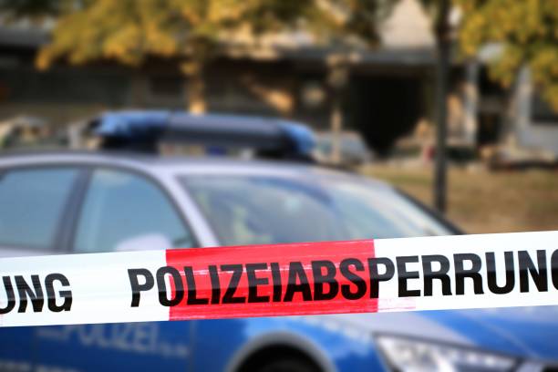 Cordon tape with the word „Polizeiabsperrung“, the german word for police cordon stock photo