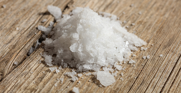 White salt on a wooden surface