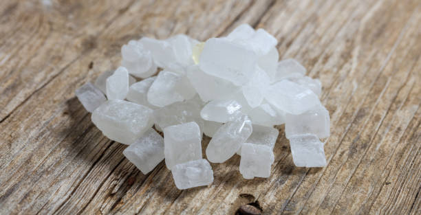 istock White sugar crystals on a wooden surface 1026396220