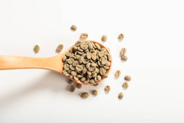 istock Green coffee beans in a wooden spoon 1026396312