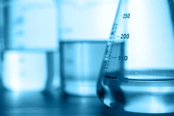 two clear beaker with water in chemical science laboratory research with molecular structure background