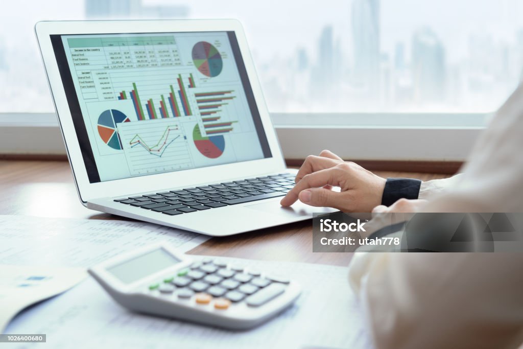 financial spreadsheet report Accounting report spreadsheet. Business women using computer prepare business report for evaluation performance. Finance Stock Photo