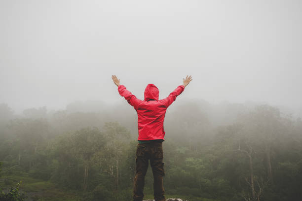 istock men standing on mountain with hand raised 1026403542