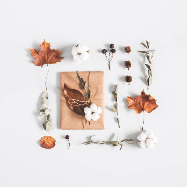 istock Autumn composition. Gift, eucalyptus branches, cotton flowers, dried leaves on pastel gray background. Autumn, fall concept. Flat lay, top view, square 1026404036