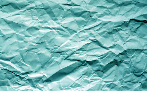 Crumpled sheet of paper with blur effect in cyan tone. Crumpled sheet of paper with blur effect in cyan tone. Abstract background and texture for design. 11904 stock pictures, royalty-free photos & images