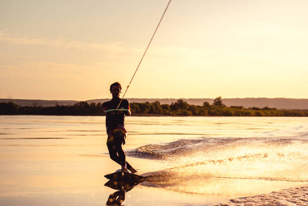 istock Wakeboarding. Athlete silhouette with splash of water 1026427330