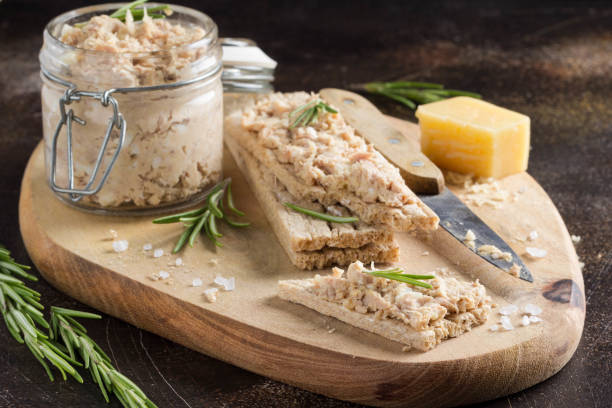 Tuna pate with egg, cheese in jar and crispy bread. Fish rillette, healthy snack, diet food stock photo