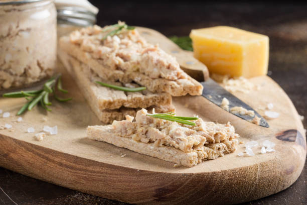 Tuna pate with egg, cheese in jar and crispy bread. Fish rillette, healthy snack, diet food stock photo