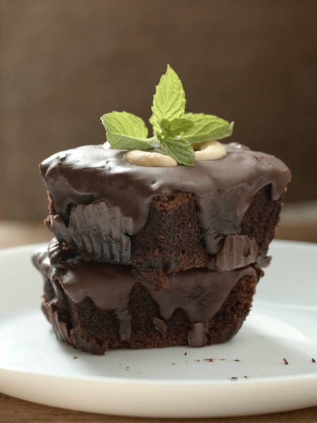istock chocolate brownies topping with cashew nut and mint 1026434578