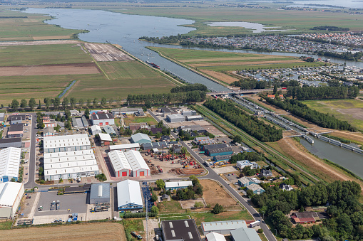Aerial view beach Dutch village Lemmer with industrial park, lake, sluice, canal, and marina harbor