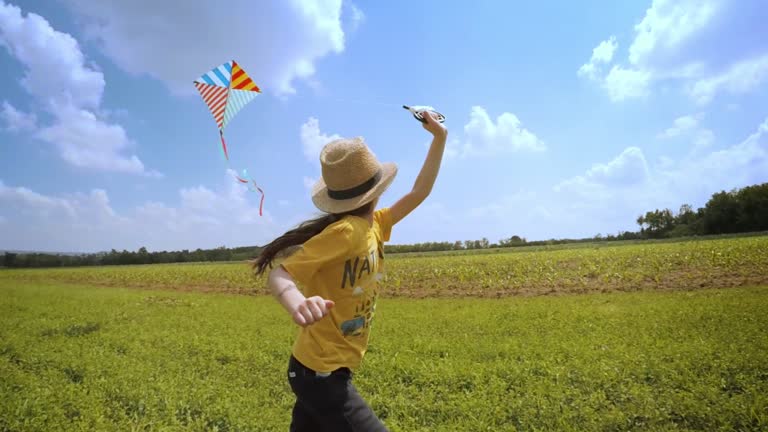 Beautiful Little Girl Flying A Kite. Happy Memories Of Her Young Days