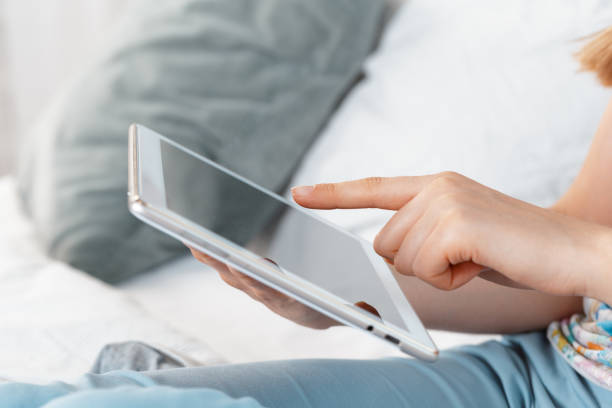 istock woman holding digital tablet, closeup 1026440588