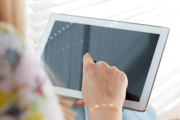 istock woman holding digital tablet, closeup 1026440608