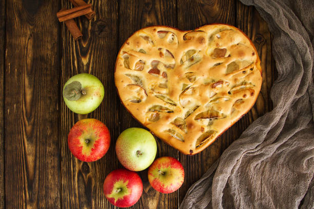 apple pie and ingredients on wooden background. Top view.