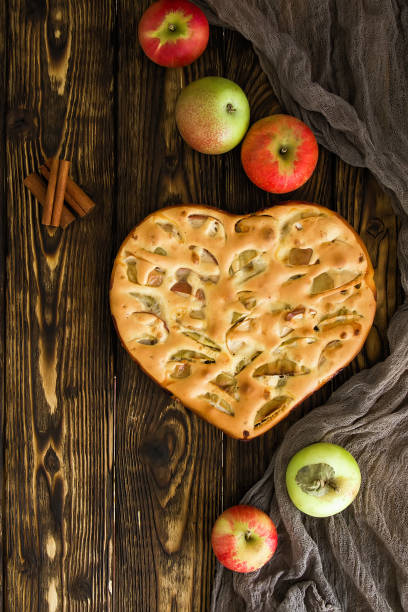 apple pie and ingredients on wooden background. Top view.