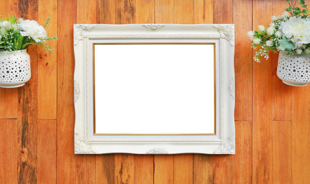 istock Antique white photo frame with empty space for your picture or text placed on wood plank wall background. 1026444728