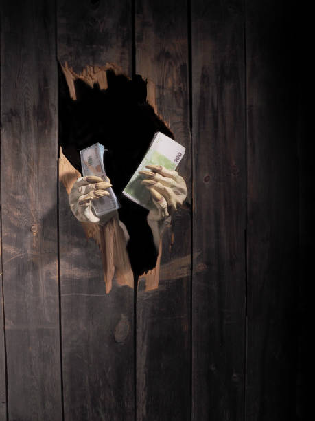 istock Zombie hand through hole cracked in rustic wood.Halloween theme 1026444746