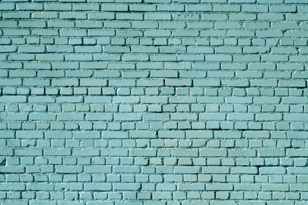 istock Cyan color old grungy brick wall surface. 1026444790