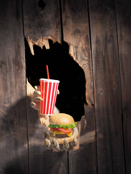 istock Zombie hand through hole cracked in rustic wood.Halloween theme 1026447614