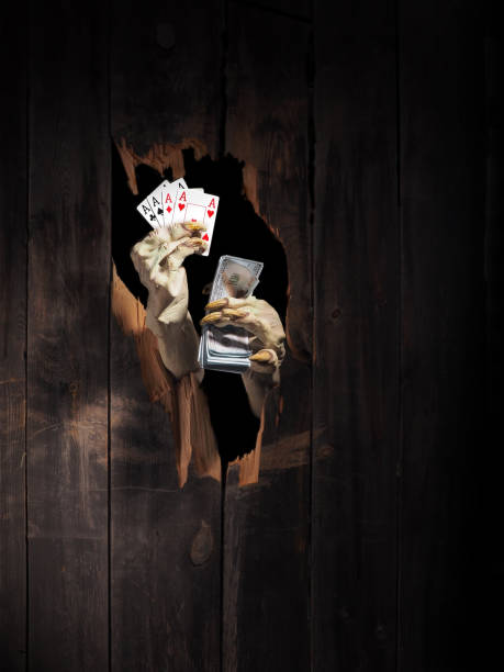 Zombie hand through hole cracked in rustic wood.Halloween theme