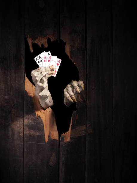 istock Zombie hand through hole cracked in rustic wood.Halloween theme 1026449854