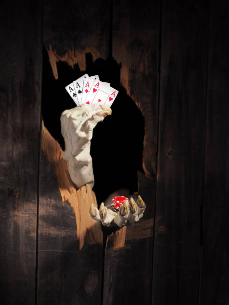 istock Zombie hand through hole cracked in rustic wood.Halloween theme 1026450944