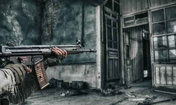 Close-up of man shooting with machine gun.