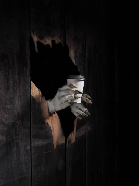 istock Zombie hand through hole cracked in rustic wood.Halloween theme 1026451932