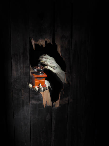 istock Zombie hand through hole cracked in rustic wood.Halloween theme 1026451984