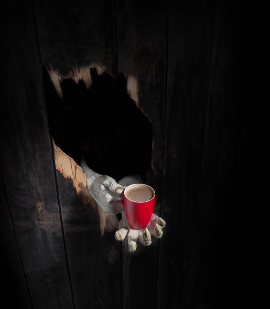 Zombie hand through hole cracked in rustic wood.Halloween theme
