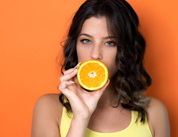 istock Woman holding orange 1026452222