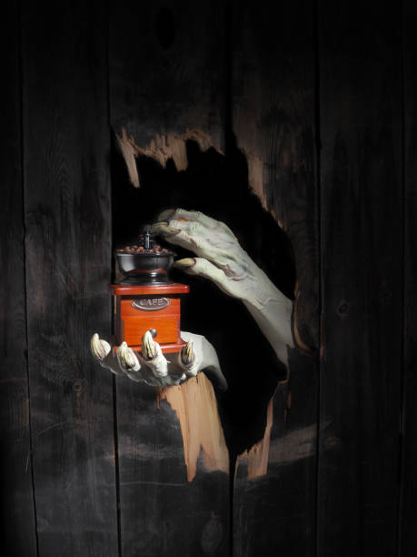 istock Zombie hand through hole cracked in rustic wood.Halloween theme 1026452252