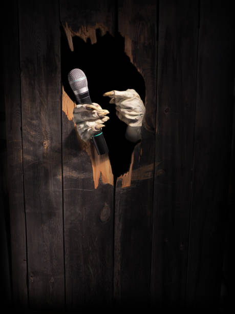 istock Zombie hand through hole cracked in rustic wood.Halloween theme 1026456614