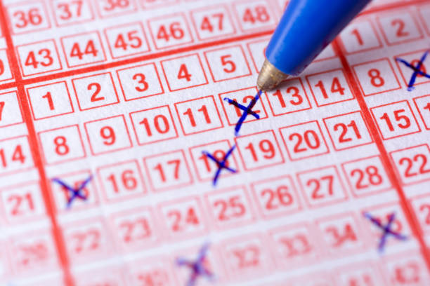 istock Completing a lottery ticket with the hope of making a profit 1026457198