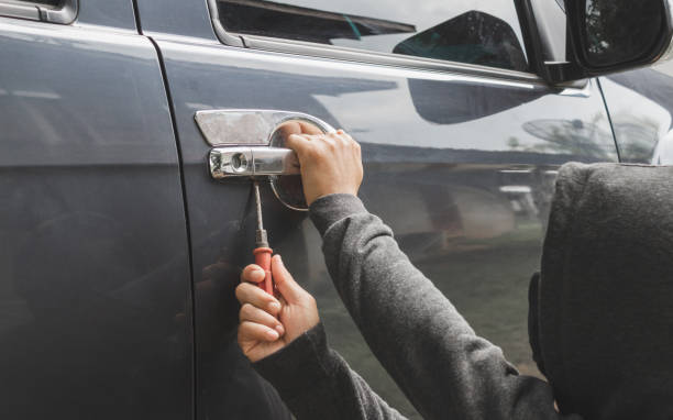 istock Man burglar stealing car 1026457588