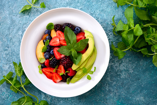 Summer detox fruits and berries salad, view from above, clean eating concept