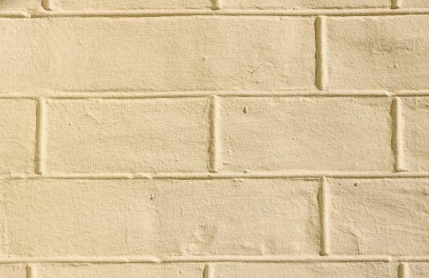istock faded natural yellow background with brick texture 1026458358