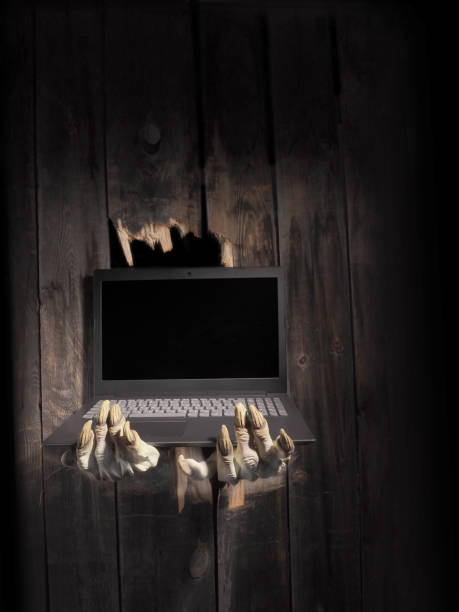 istock Zombie hand through hole cracked in rustic wood.Halloween theme 1026458654