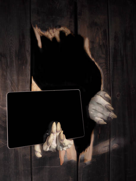 istock Zombie hand through hole cracked in rustic wood.Halloween theme 1026458674
