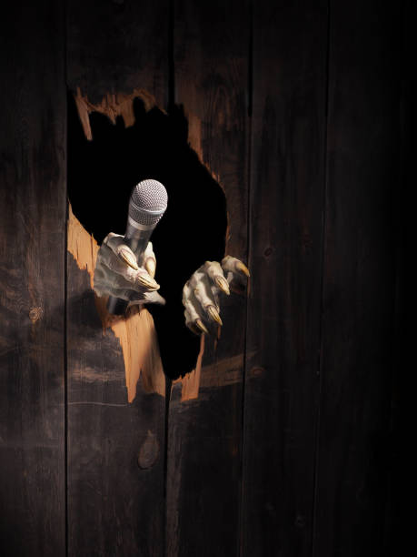 istock Zombie hand through hole cracked in rustic wood.Halloween theme 1026469678