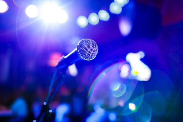 istock Microphone on stage against a background of auditorium. 1026472960
