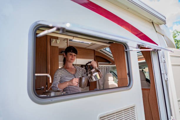 istock Woman cooking in camper, motorhome interior 1026472994