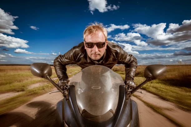 istock Biker racing on the road 1026473044
