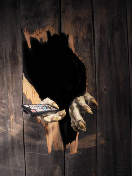 istock Zombie hand through hole cracked in rustic wood.Halloween theme 1026475954