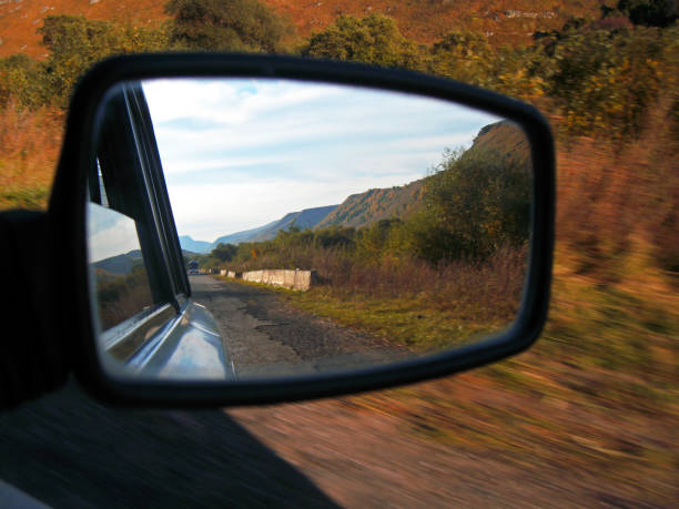 istock Reflection in the mirror of auto. Road and landscape 1026476500